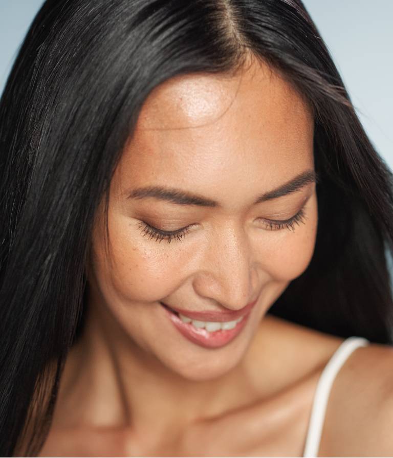 woman smiling after Scupltra treatment